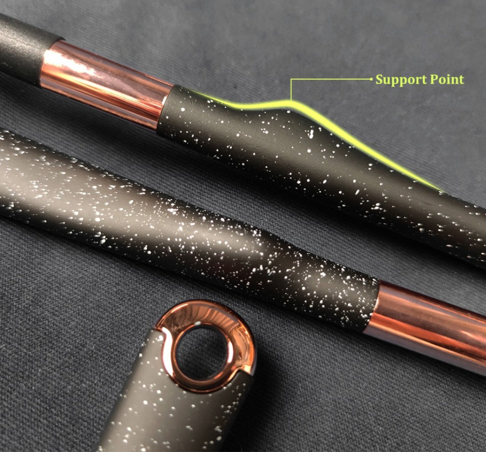 Close-up of rose-gold-capped utensil handle with black silicone tools and speckle pattern