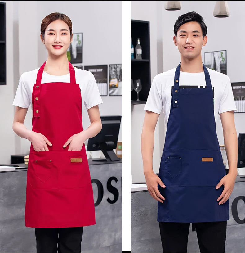 Red and navy waterproof canvas chef aprons with front pockets and buttoned straps