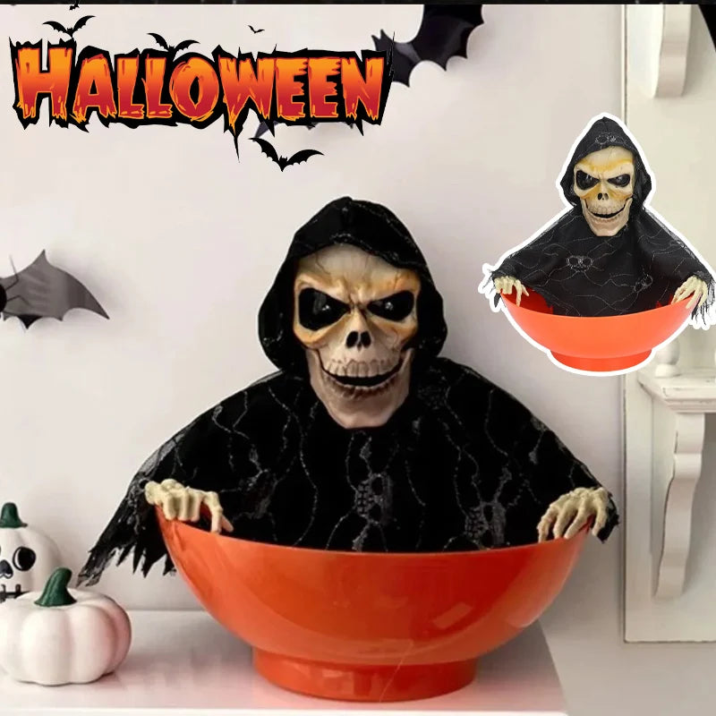 Orange skull bowl haunted house prop with hooded skeleton face, arms over the rim