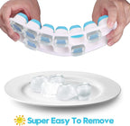Mint green and sky blue silicone ice cube tray with spill-resistant lid, releasing cubes easily