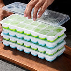 Ice cube tray with clear lid; mint green and blue cavities; spill-resistant design