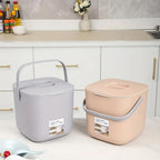 Small countertop compost bins in gray and beige with flip-top lids and side handles