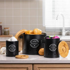 Three vented black storage canisters with bamboo lids for potatoes, onions, garlic