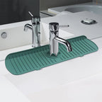 Green silicone sink splash guard and drain mat with ridged surface along sink edge