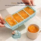 Mint green ice-cube style freezer tray with hinged release press feature