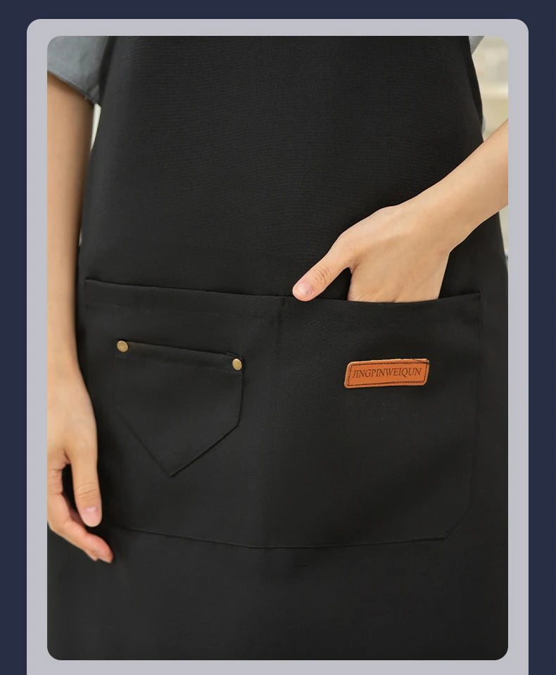Matte black waterproof canvas chef apron with adjustable neck and large front pockets