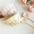 Cream and yellow ceramic bowl and spoon set, bear and star pattern, stacked angle