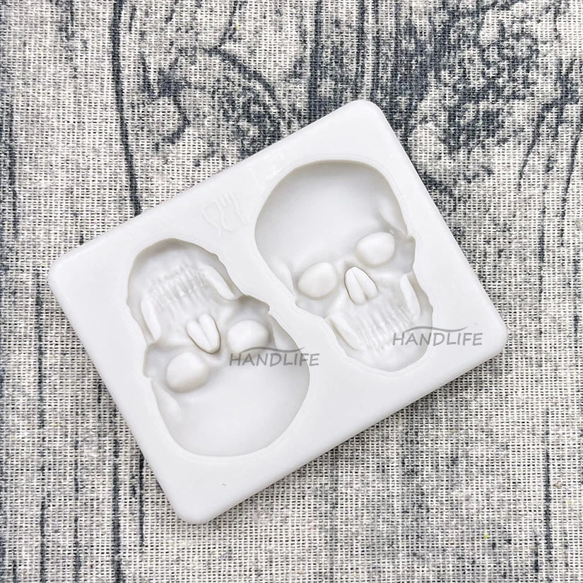 Skull silicone cake mold tray, angled view, showing two white skull cakes