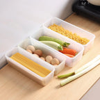 Clear airtight storage box with blue lid containing assorted food items