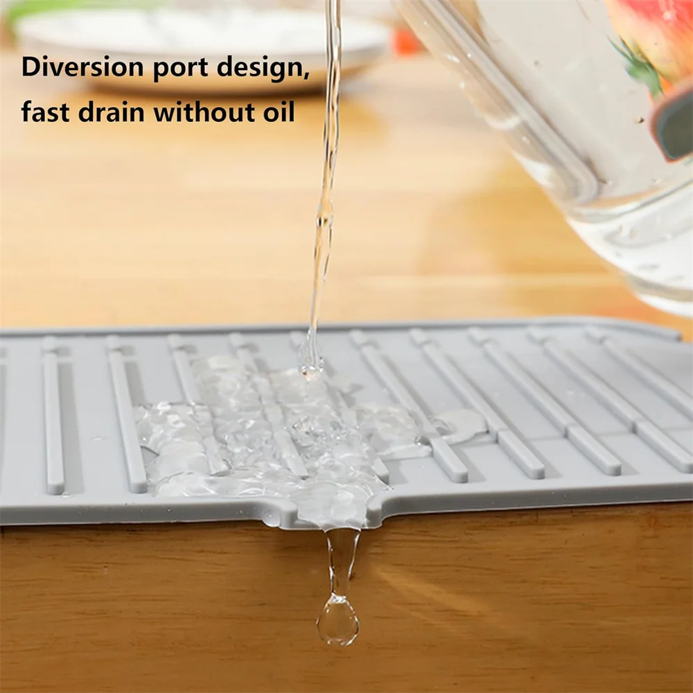 Gray silicone faucet sink splash guard mat with water diverted through drain channels