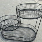 Set of round black wire baskets with curved frames and grid bottoms