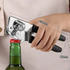 Manual can opener gripping a green bottle; chrome head with black handles