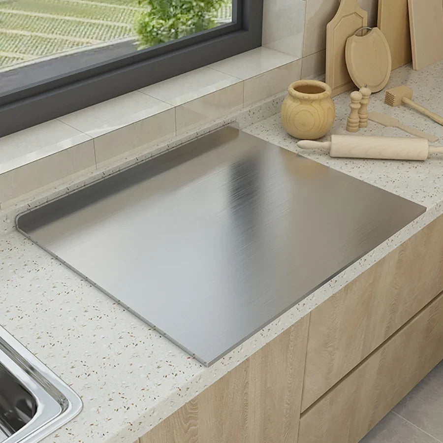 Stainless steel pastry and cutting board set into countertop corner