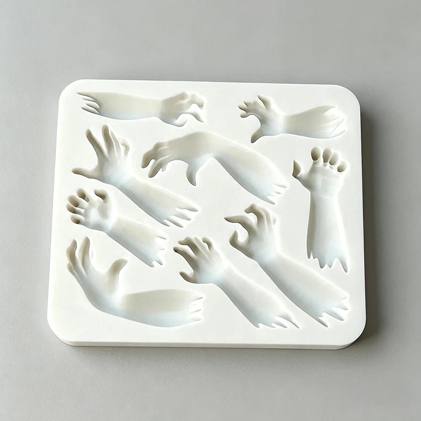 Rectangular silicone mold with Halloween hand and arm relief cavities for sugarcraft