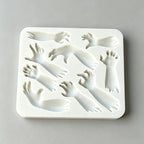 Rectangular silicone mold with Halloween hand and arm relief cavities for sugarcraft
