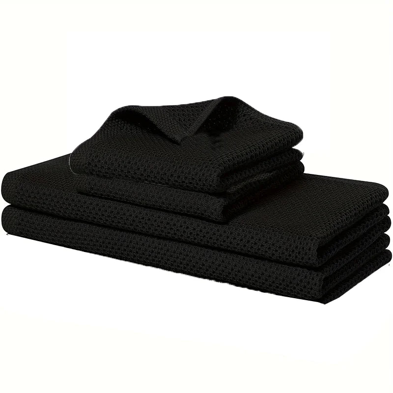 Black waffle weave kitchen towels stack folded for storage