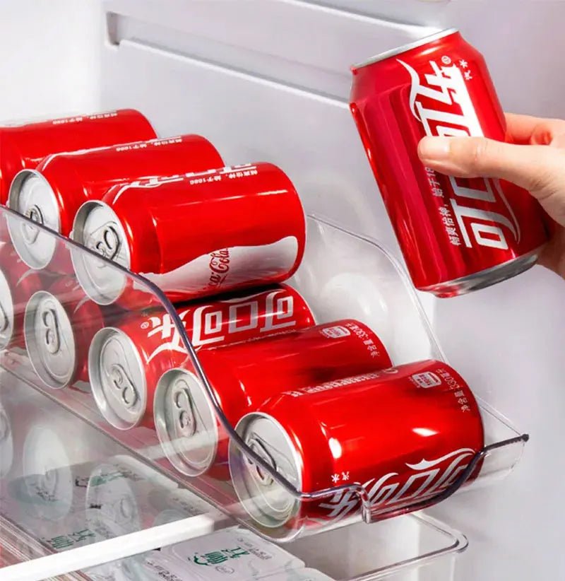 Clear can holder bin with built-in handles storing stacked soda cans in the fridge