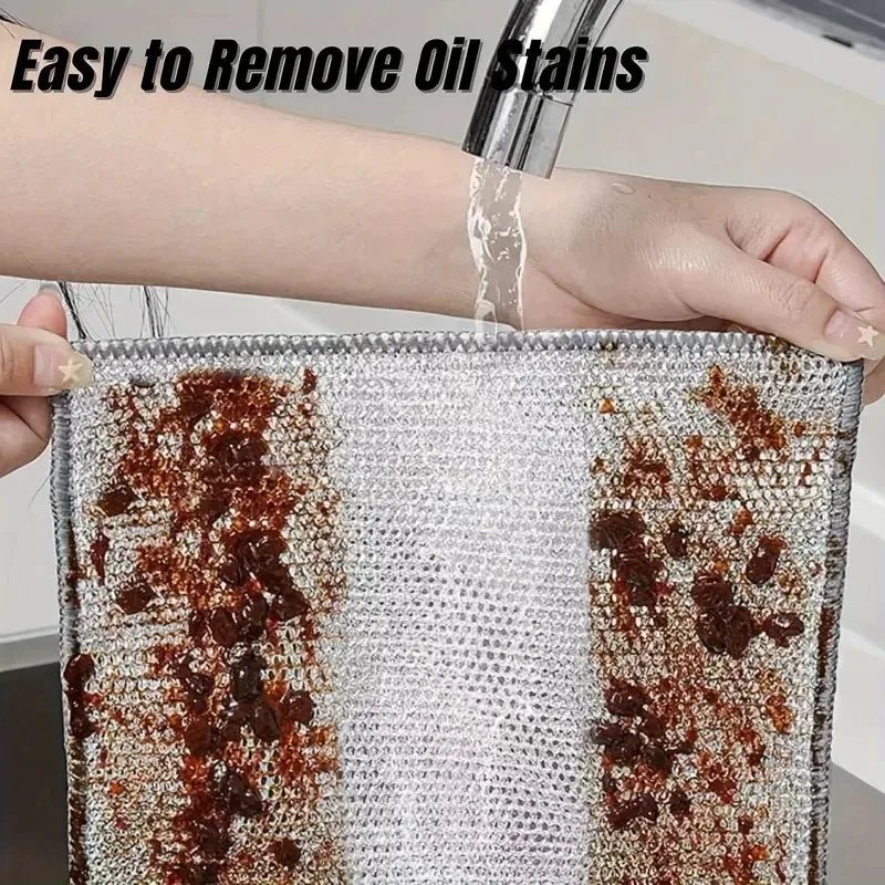 Grey wire mesh cloth showing coffee-brown stains being rinsed under a tap