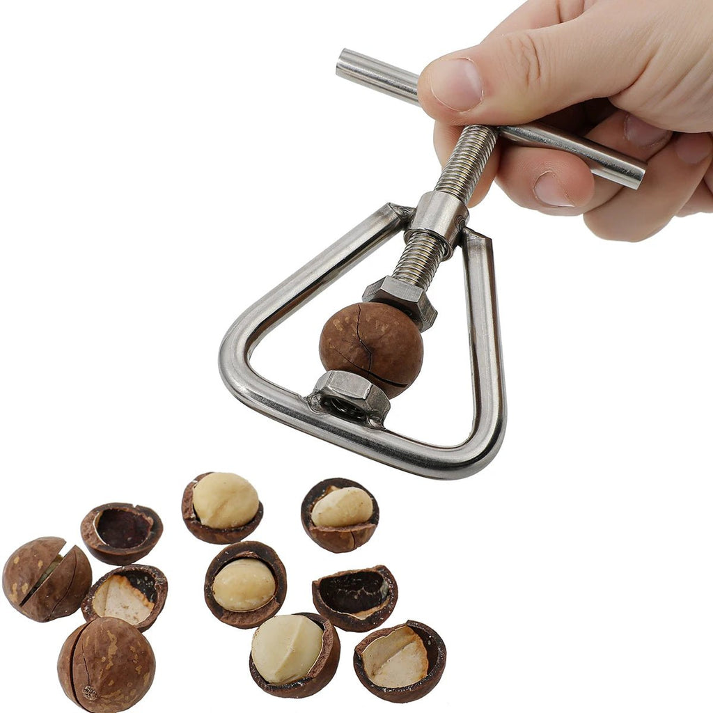 Hands using stainless steel manual nutcracker and sheller on a nut
