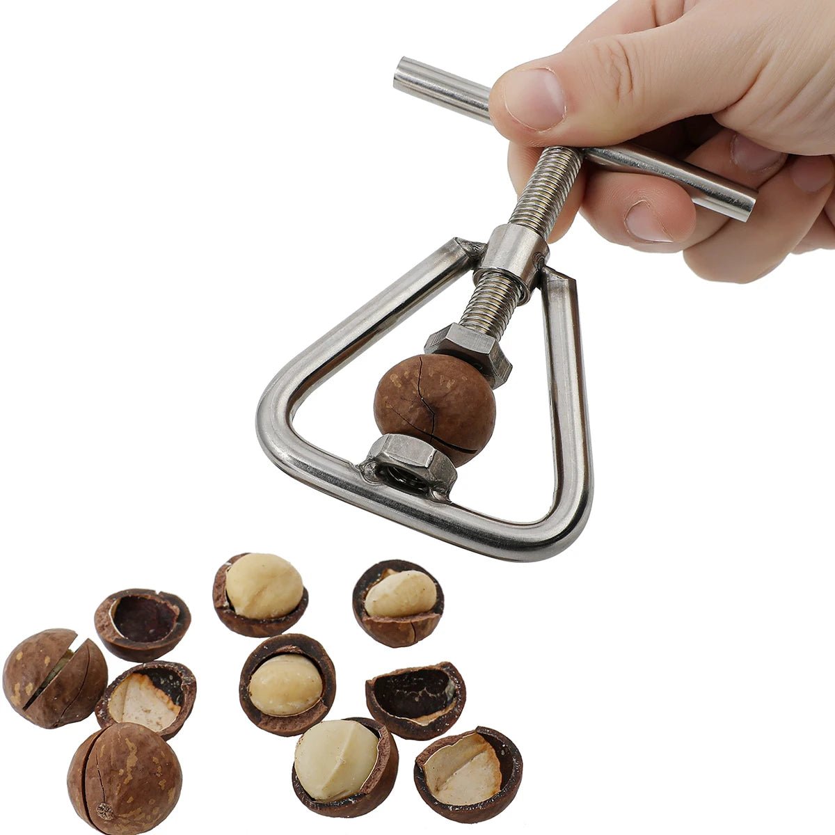 Hands using stainless steel manual nutcracker and sheller on a nut