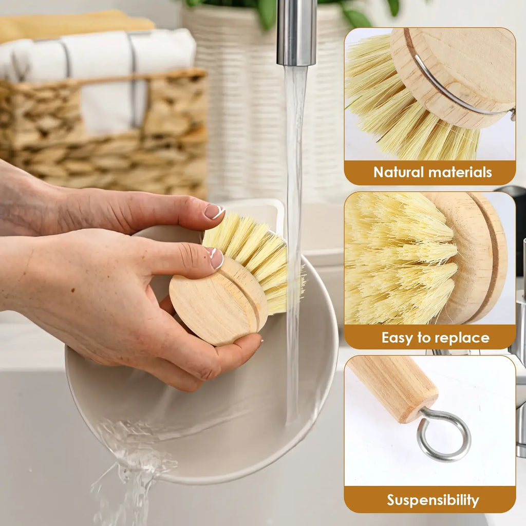 Round wooden dish scrub brush head with yellow bristles; hand holds it in a sink