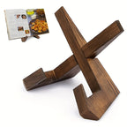 Wooden cookbook stand with interlocking cross base, holding an open recipe book