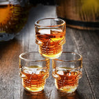 Set of 3 amber skull shot glasses with raised skull face detailing