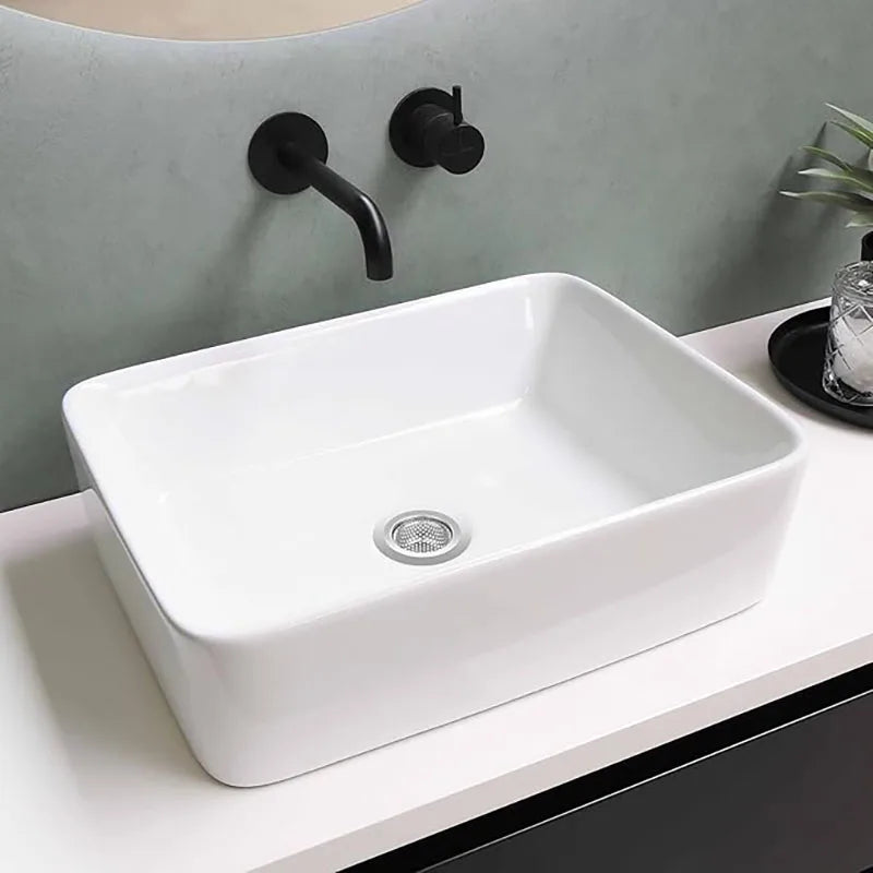 Stainless steel sink strainer basket fitted in a white vessel sink drain