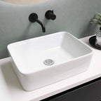 Stainless steel sink strainer basket fitted in a white vessel sink drain