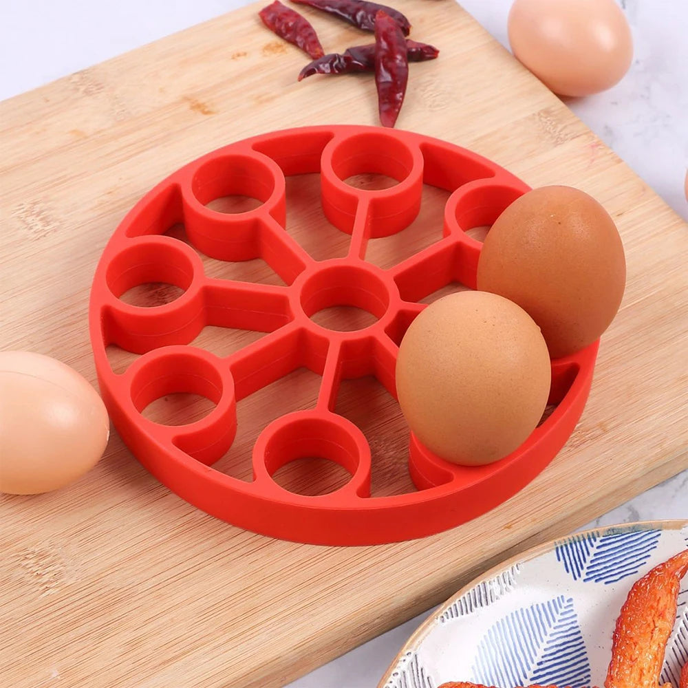 Red silicone 9-hole egg steamer rack with circular compartments and center stem