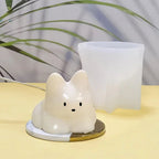 White cat pudding silicone mold with cat insert in front of upright mold