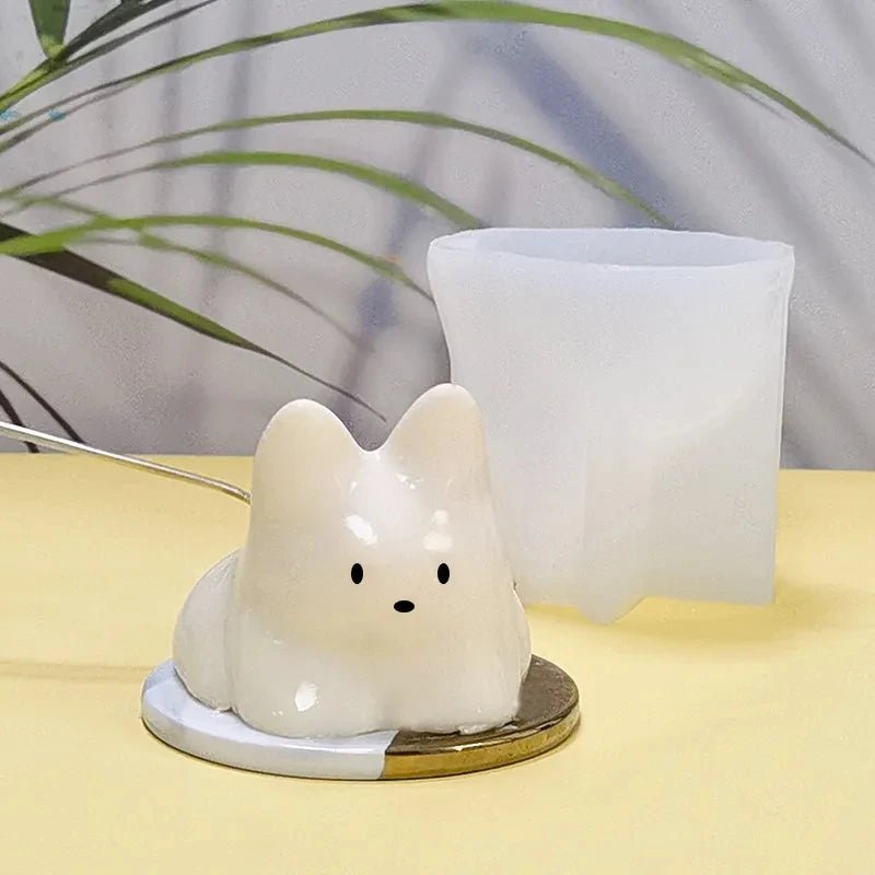White cat pudding silicone mold with cat insert in front of upright mold