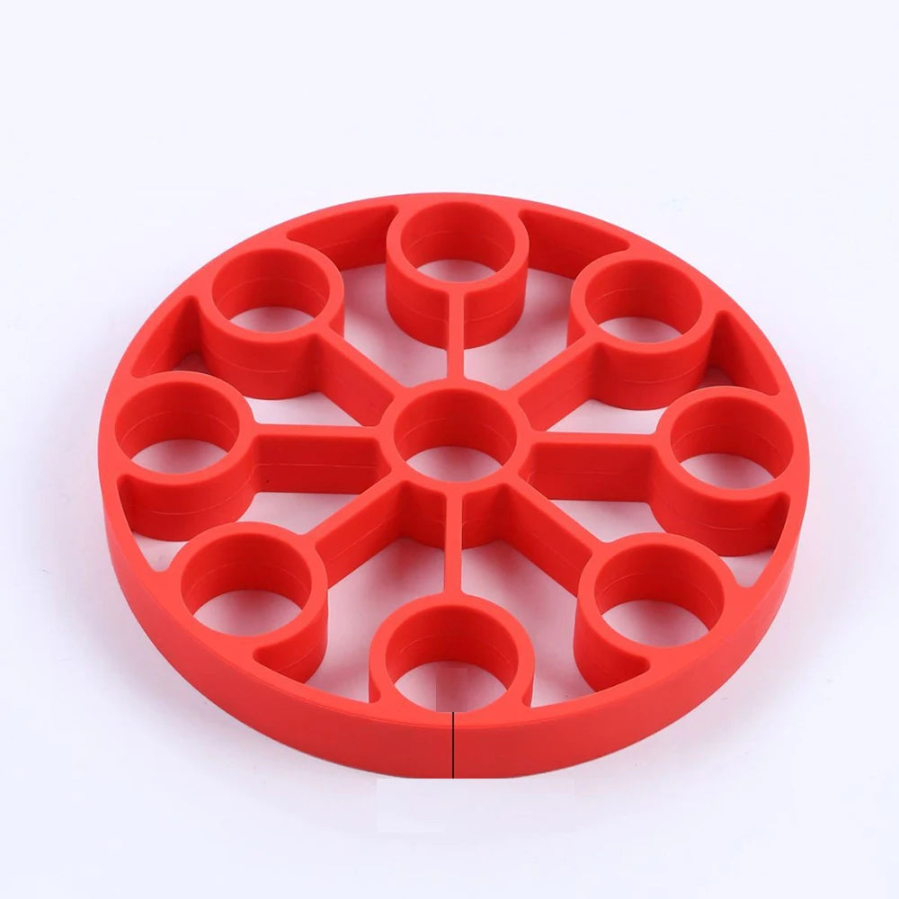 Red silicone 9-hole egg steamer rack, evenly spaced circular wells
