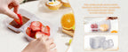 Two-compartment snack containers with secure lids; hand portioning fruit and snacks