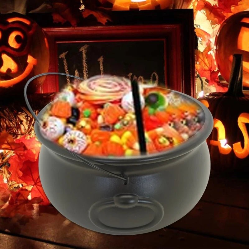 Black cauldron candy bucket filled with Halloween candies and a hanging hook