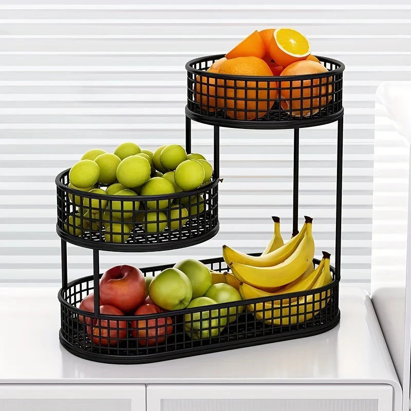 Black multi-layer stainless fruit basket with three round wire tiers, holding assorted produce