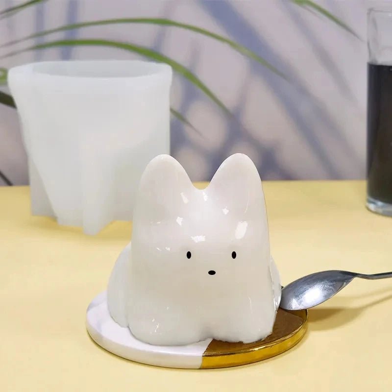 White cat-shaped pudding insert on base beside upright mold part