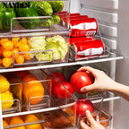 Clear stackable refrigerator storage bin with built-in handles, filled with vegetables