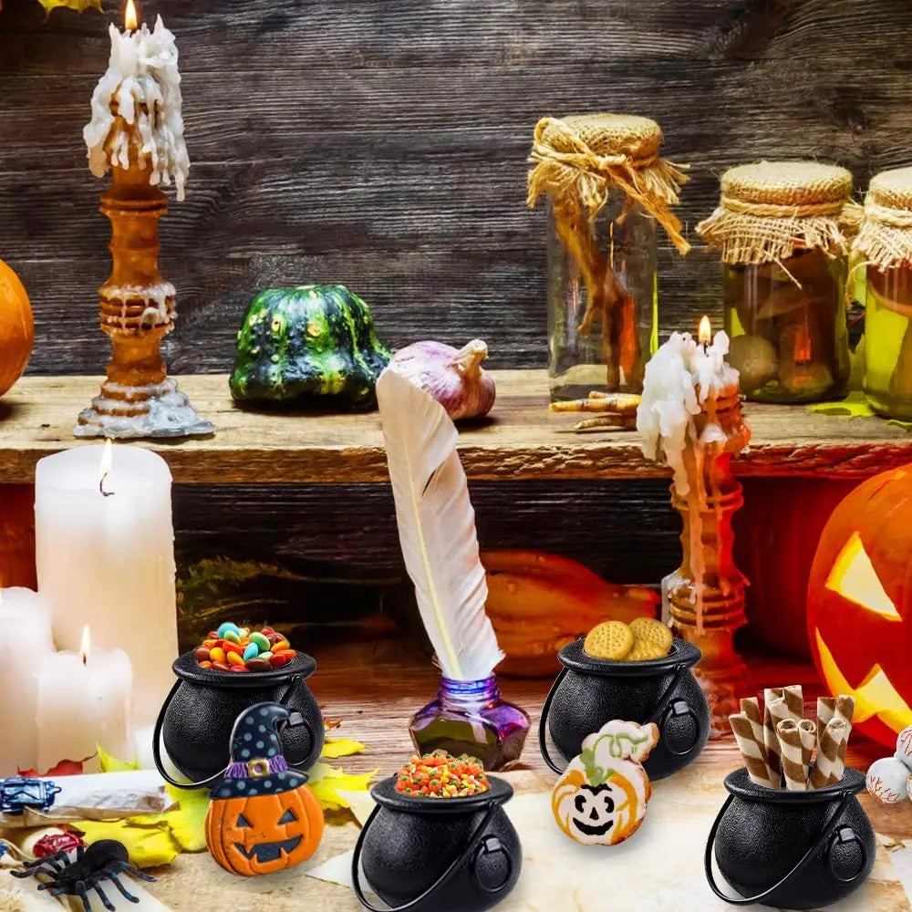 Black cauldron candy bowls with handles and round openings, textured finish on party table