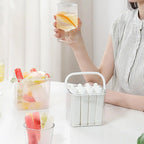 White silicone ice stick tray and clear ice bin filled with molded popsicles