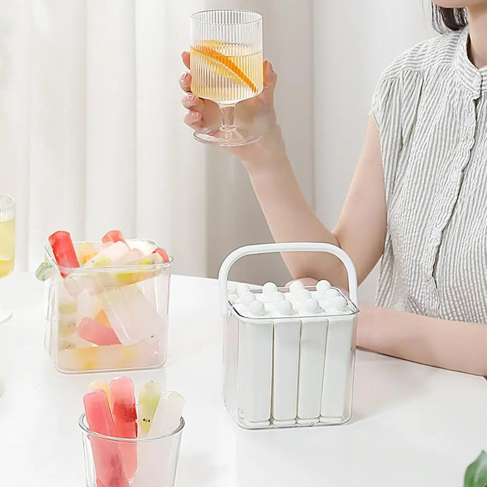 White silicone ice stick tray and clear ice bin filled with molded popsicles