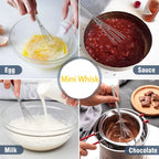 Stainless steel balloon whisk beating sauce-like mixture in a bowl, loop handle