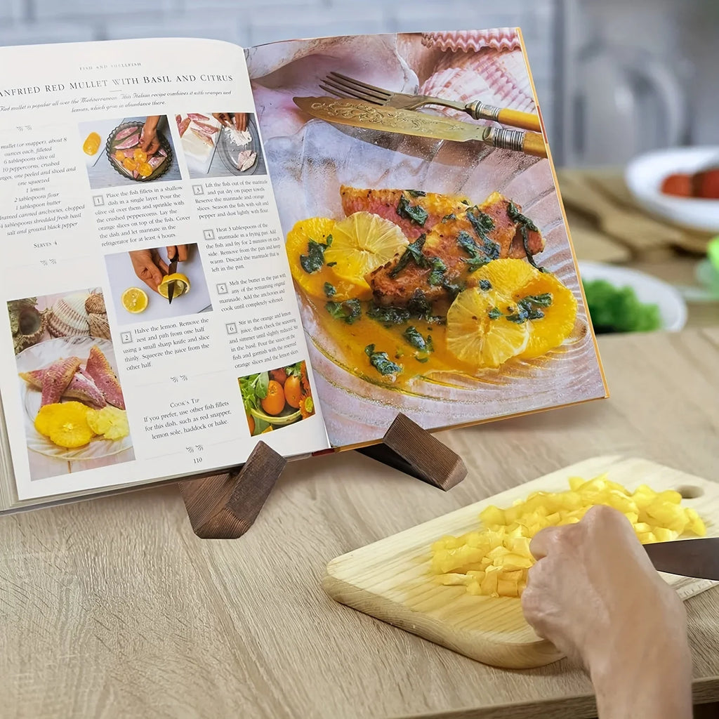 Wooden cookbook stand with interlocking cross base holding an open recipe book