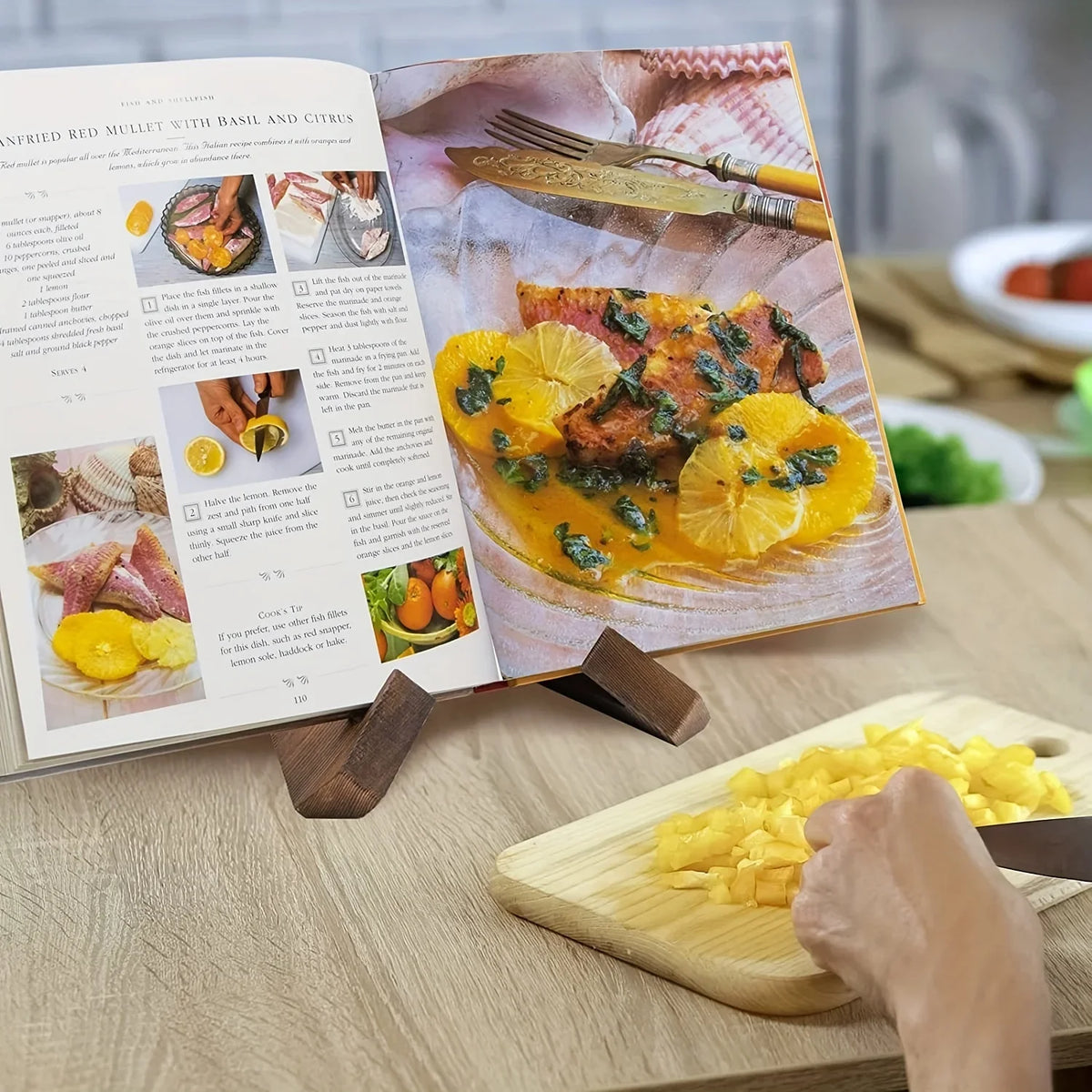 Wooden cookbook stand with interlocking cross base holding an open recipe book