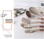Beige silicone cooking utensil set with rose-gold handles on countertop display