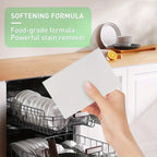 White detergent sheet in hand over open dishwasher with softening formula pack