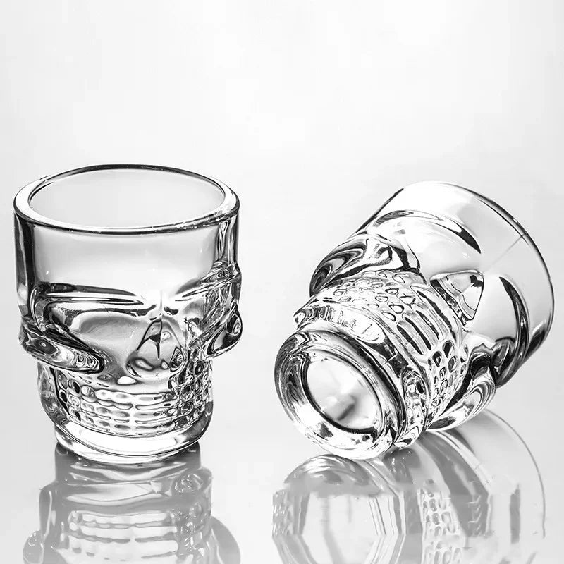 Clear skull shot glass with mirrored skull face and ear handle accents