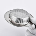 Stainless steel sink strainer basket with domed mesh, close-up on rim