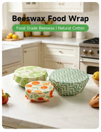 Reusable beeswax food wrap pack with teal zigzag and green fruit-pattern wraps