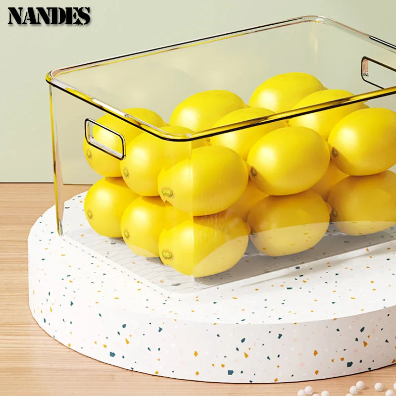 Clear bin with built-in handles for holding yellow lemons on a round turntable